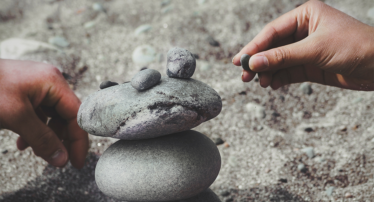 Person building and balancing rocks 