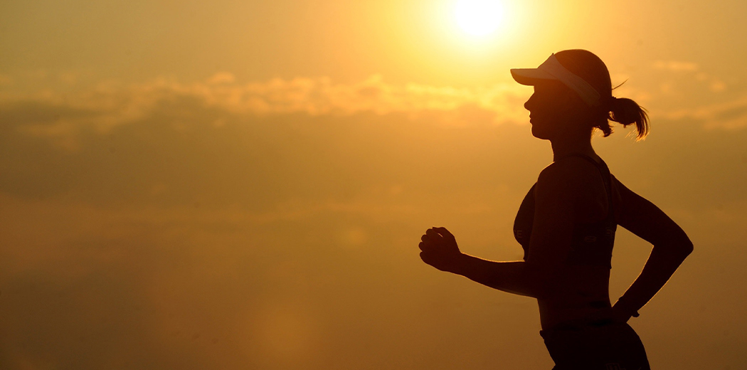 Women jogging with sunset in the background